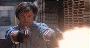 Nick Davis (Viggo Mortensen) opens fire with both guns blazing.